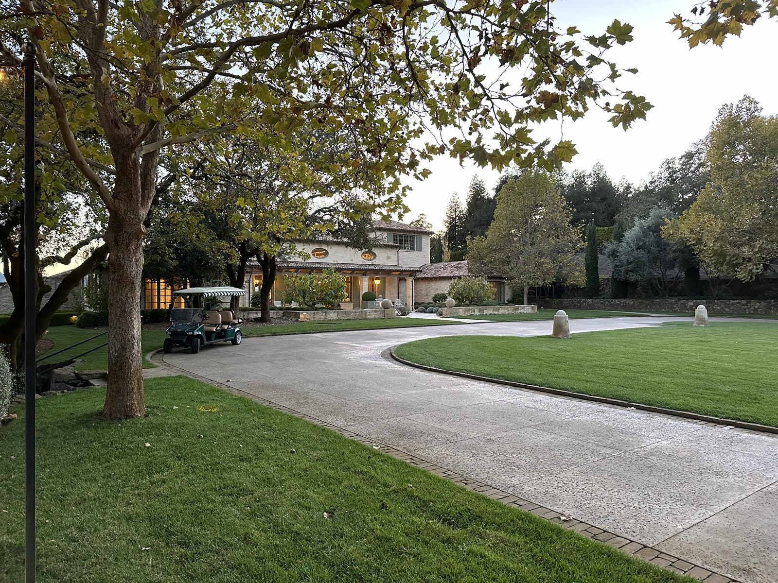 Estate driveway at dusk with warm lighting