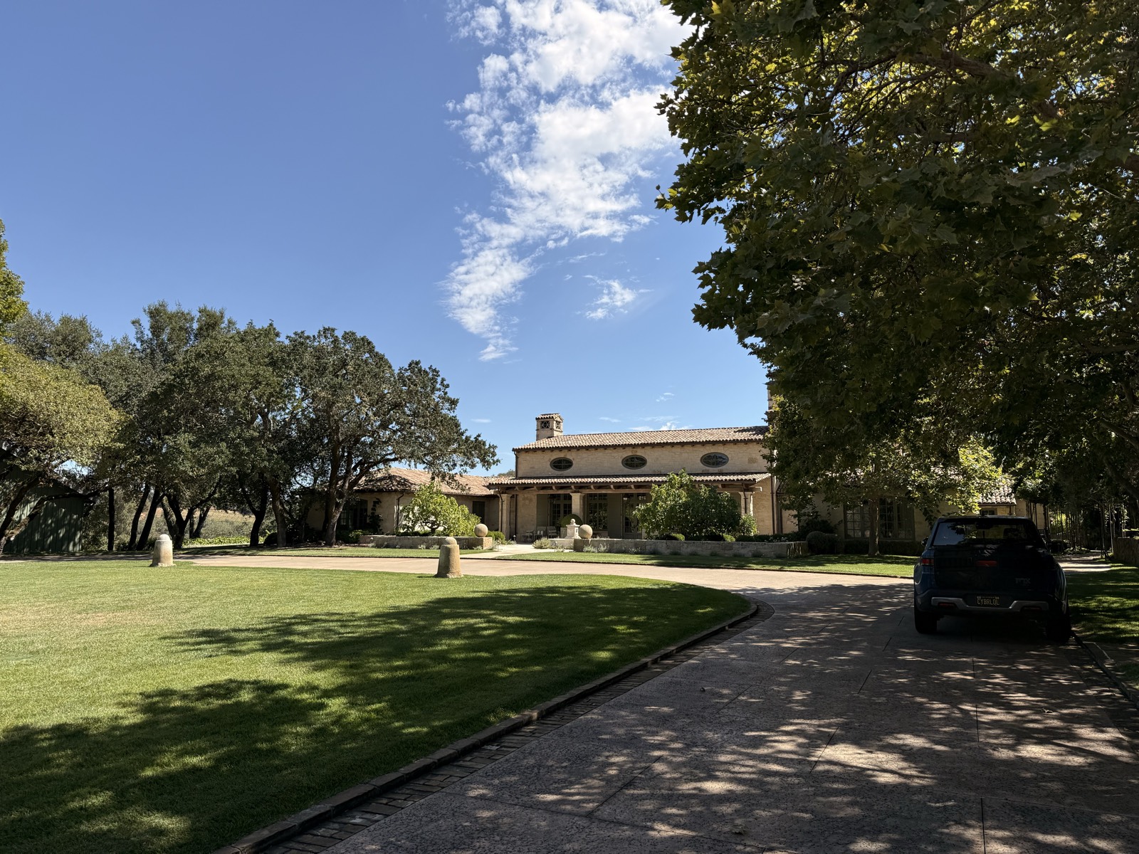 Estate front with driveway and blue sky