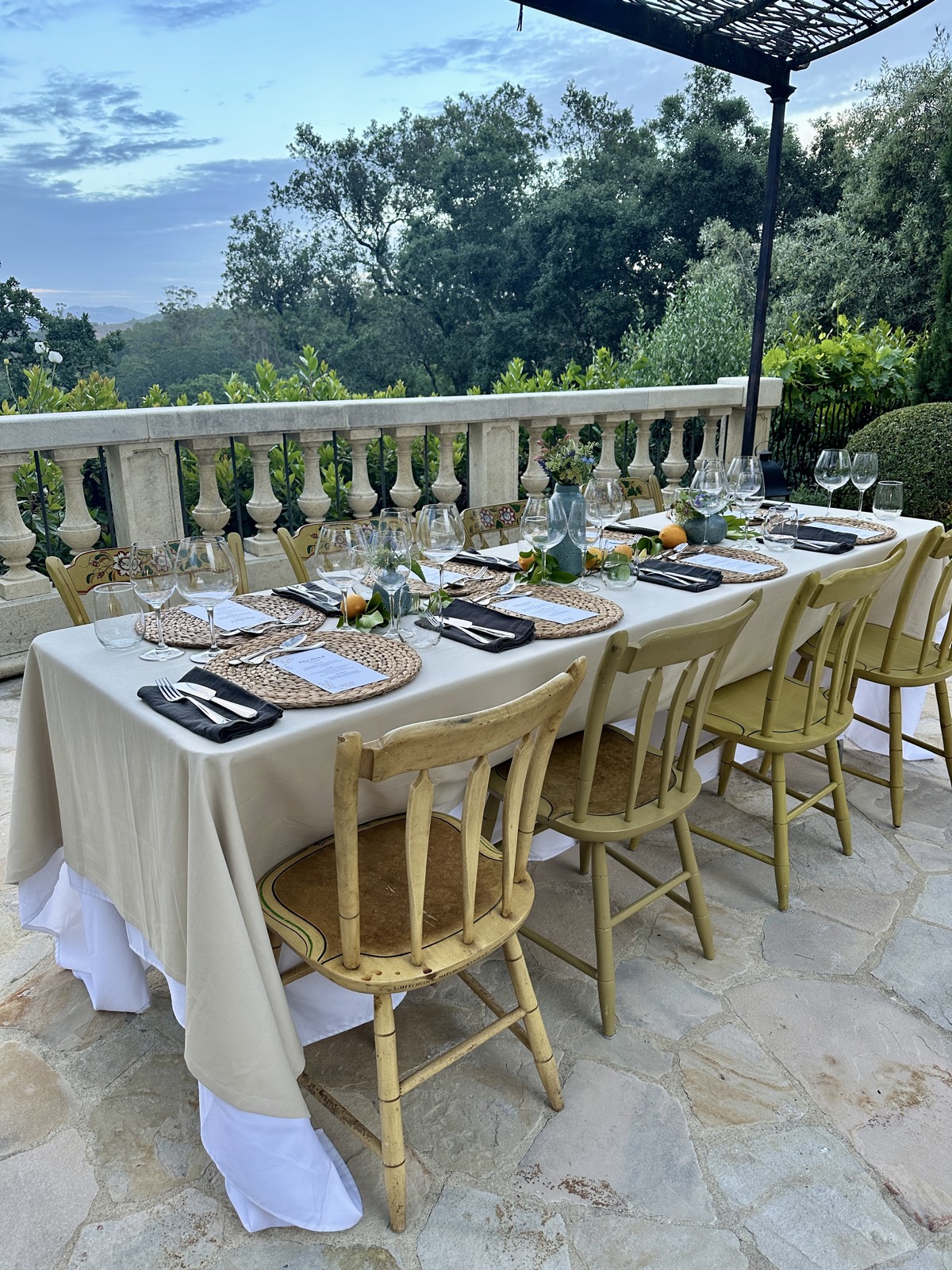 Outdoor dinner table on the stone terrace at dusk